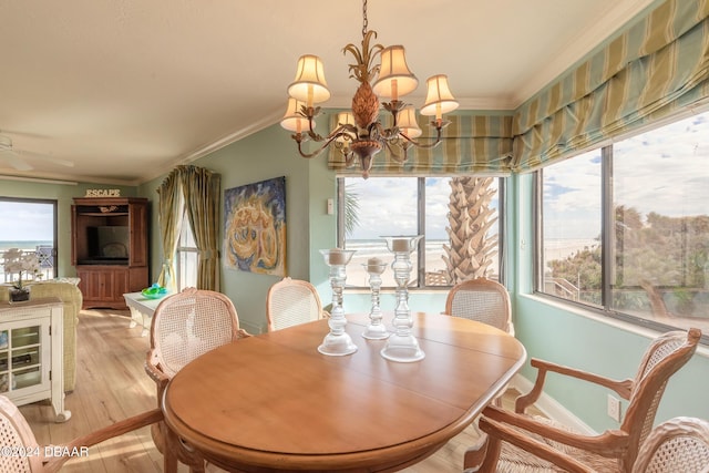 dining area with light hardwood / wood-style floors, ceiling fan with notable chandelier, and ornamental molding