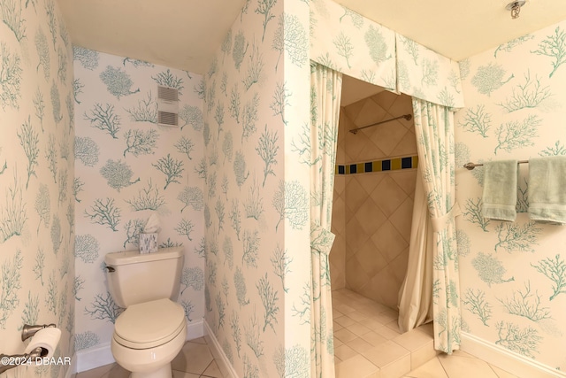 bathroom with tile patterned flooring and toilet