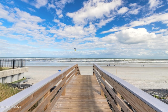 surrounding community with a water view and a view of the beach