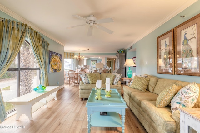 living room featuring ceiling fan with notable chandelier, light wood-type flooring, and ornamental molding