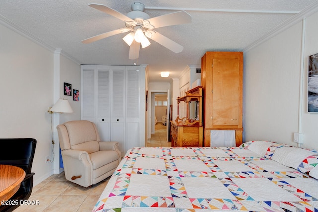 bedroom with light tile patterned floors, a textured ceiling, ornamental molding, and a closet