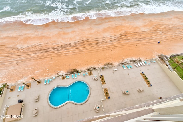 birds eye view of property featuring a view of the beach and a water view