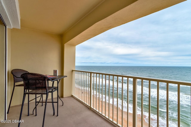 balcony with a view of the beach and a water view