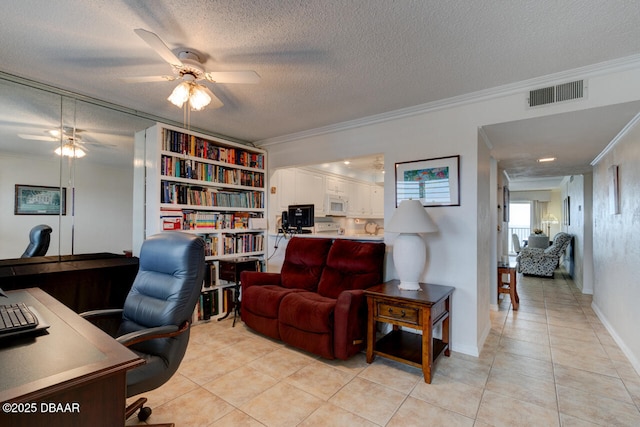 office featuring ornamental molding, visible vents, ceiling fan, and a textured ceiling