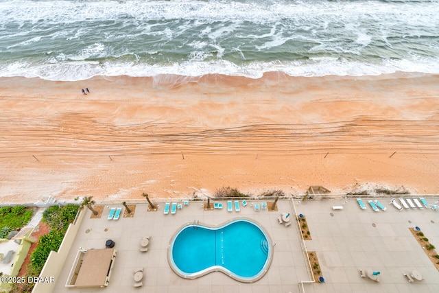 aerial view featuring a water view and a beach view