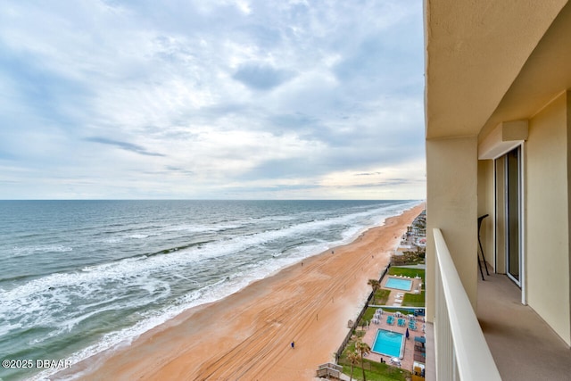 balcony featuring a water view and a view of the beach