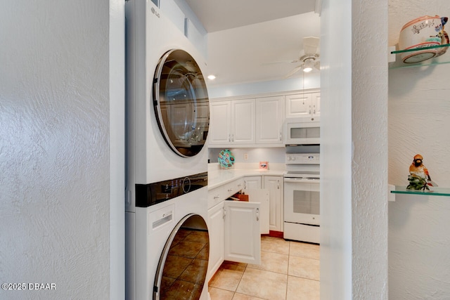 washroom with light tile patterned floors, laundry area, a textured wall, ceiling fan, and stacked washing maching and dryer