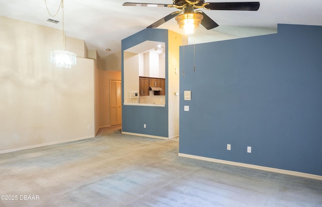 unfurnished living room featuring lofted ceiling, light colored carpet, and ceiling fan