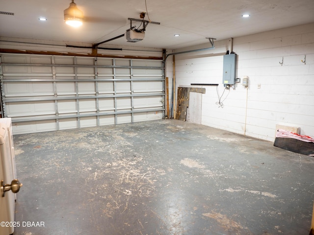 garage featuring a garage door opener and electric panel