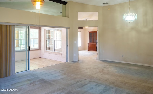 carpeted empty room featuring ceiling fan and high vaulted ceiling