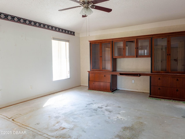 317 Glenbriar Cir, Daytona Beach, FL 32114 - empty room featuring unfinished concrete floors, a textured ceiling, a ceiling fan, and baseboards