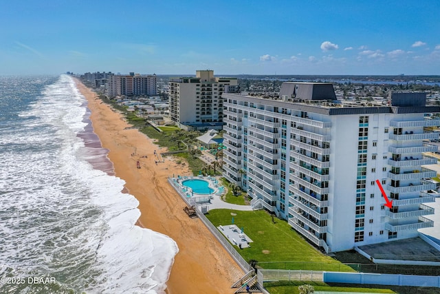 bird's eye view with a water view, a view of the beach, and a city view