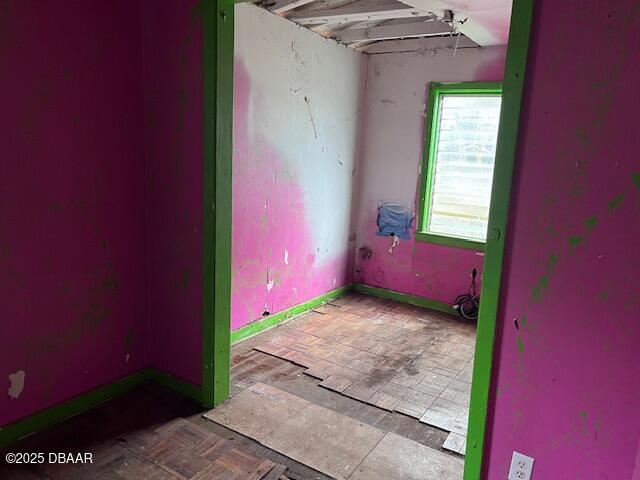 unfurnished room featuring parquet flooring