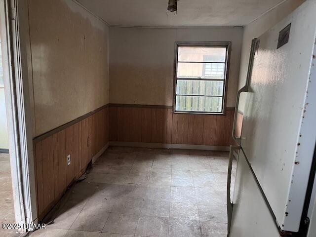 spare room featuring wooden walls