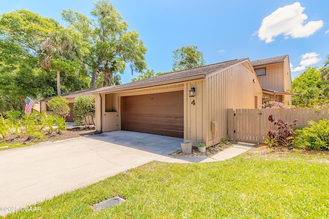 garage with driveway and a gate