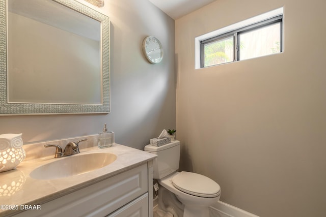 bathroom featuring toilet and vanity