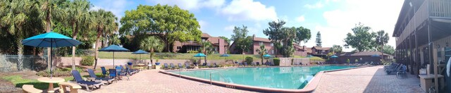 community pool with a patio and a residential view