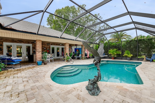 view of pool with a lanai, a patio, and french doors