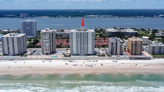 aerial view featuring a view of city, a water view, and a beach view