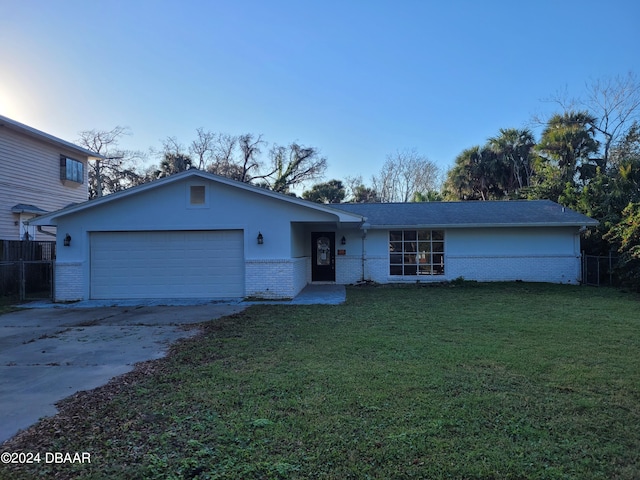 view of front of property featuring a garage and a front lawn