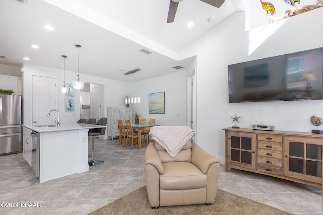 living room with ceiling fan, light tile patterned floors, and sink