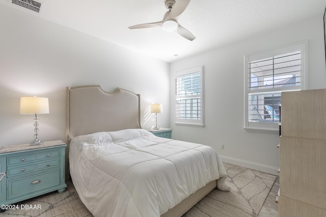 bedroom with ceiling fan and light colored carpet