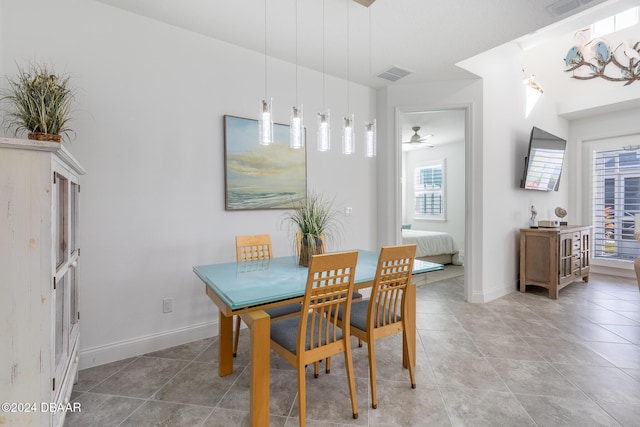 tiled dining room with ceiling fan