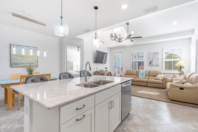 kitchen with sink, stainless steel dishwasher, pendant lighting, a kitchen island with sink, and white cabinets