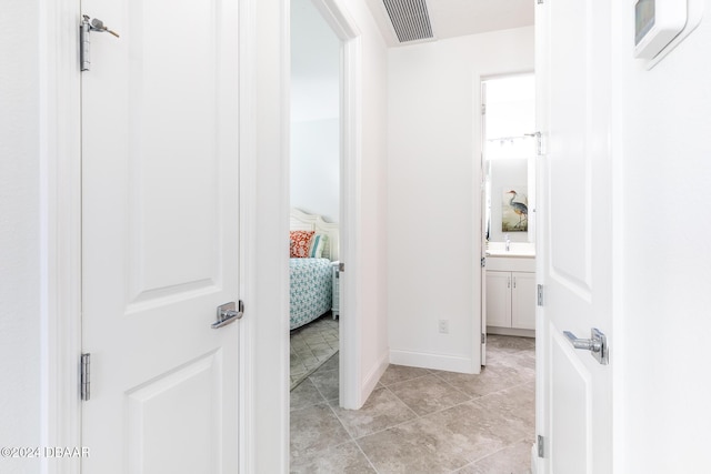 hallway featuring light tile patterned floors