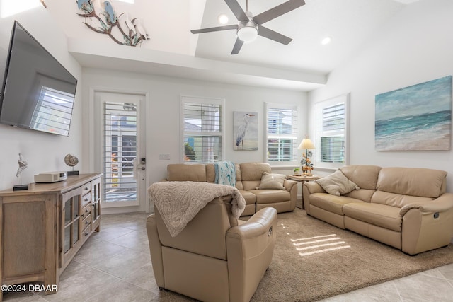 living room featuring ceiling fan, light tile patterned floors, and vaulted ceiling