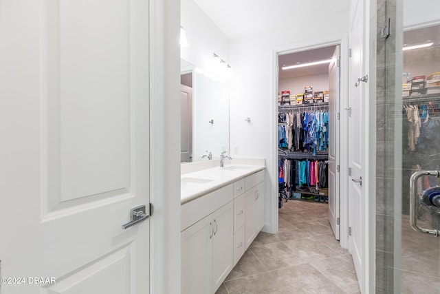 bathroom featuring tile patterned floors, vanity, and a shower with door