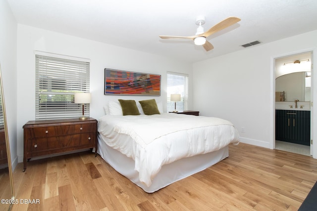 1327 Wayne Ave, New Smyrna Beach, FL 32168 - bedroom featuring light wood-style floors, ensuite bathroom, and a ceiling fan