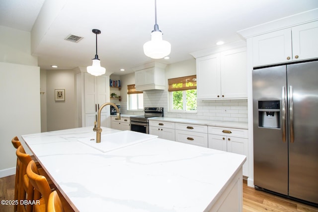 1327 Wayne Ave, New Smyrna Beach, FL 32168 - kitchen featuring stainless steel appliances, light wood-style flooring, backsplash, white cabinets, and open shelves