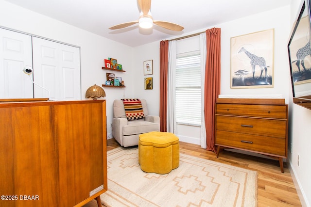 1327 Wayne Ave, New Smyrna Beach, FL 32168 - living area with light wood-style flooring and a ceiling fan