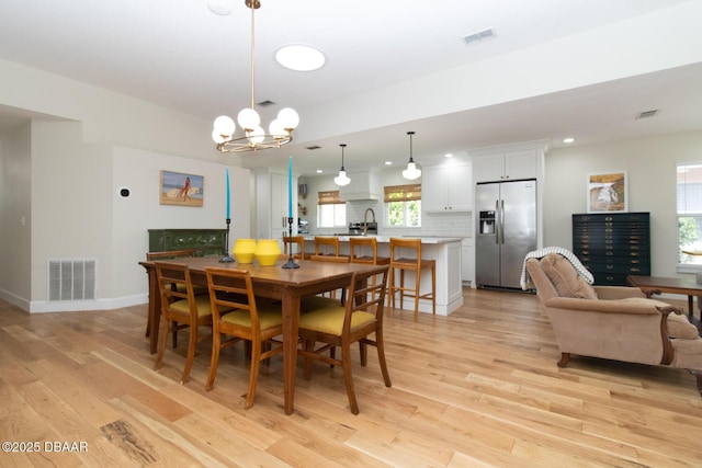1327 Wayne Ave, New Smyrna Beach, FL 32168 - dining area featuring light wood-style floors, a chandelier, and recessed lighting