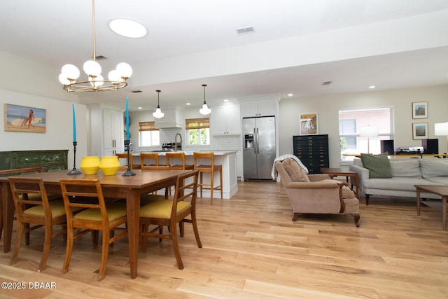 1327 Wayne Ave, New Smyrna Beach, FL 32168 - dining room with recessed lighting, light wood-style floors, and a chandelier