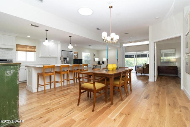 1327 Wayne Ave, New Smyrna Beach, FL 32168 - dining space with light wood finished floors, recessed lighting, and a chandelier