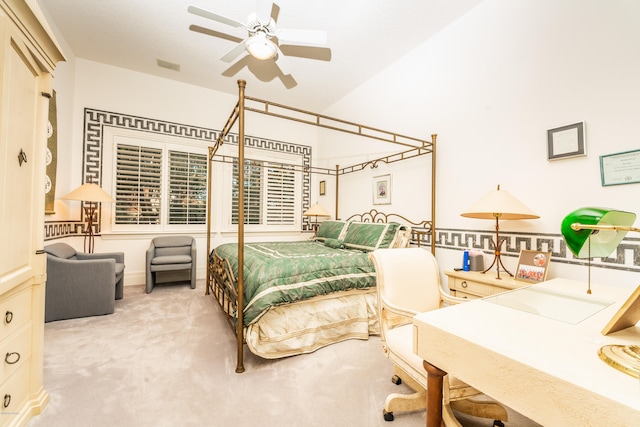 carpeted bedroom featuring lofted ceiling and ceiling fan