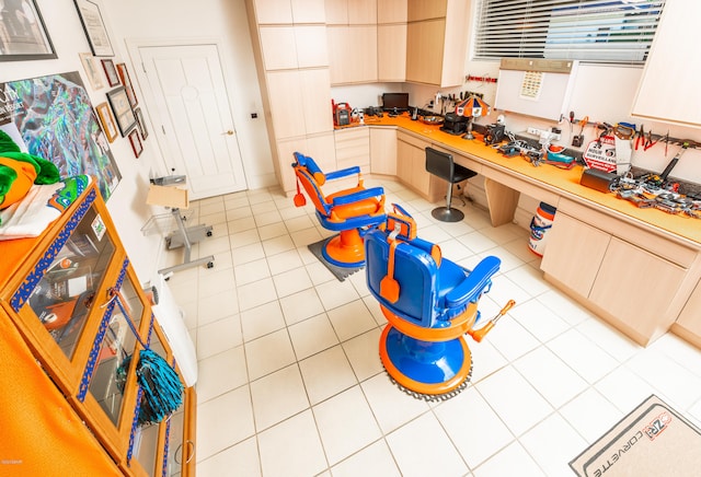 kitchen with light brown cabinets and light tile patterned floors