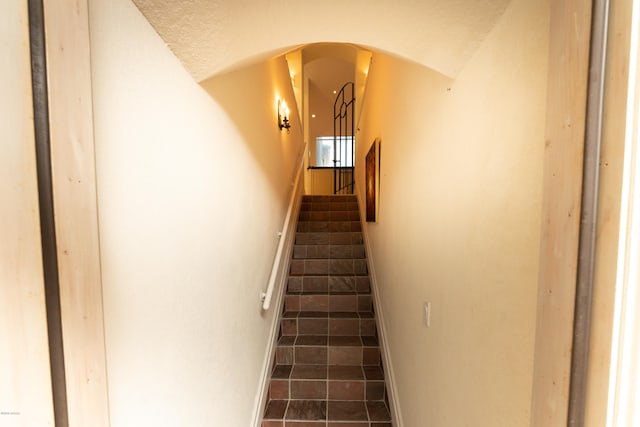 staircase featuring tile patterned flooring