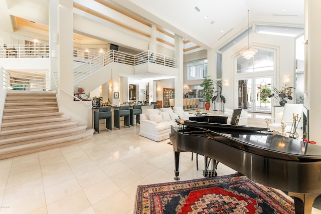 misc room featuring a high ceiling, beamed ceiling, french doors, and light tile patterned flooring