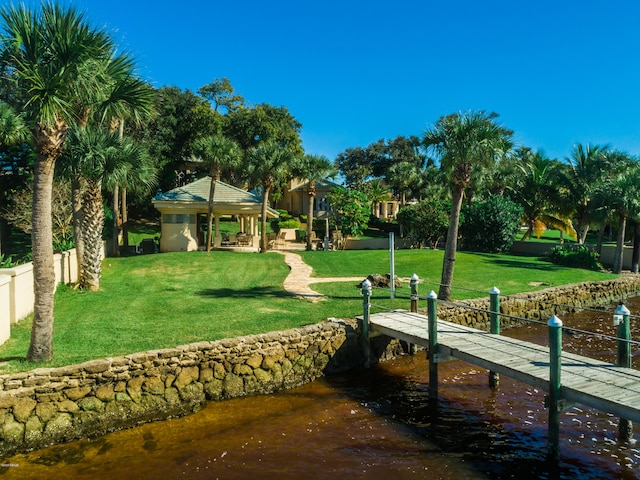 view of dock featuring a gazebo, a water view, and a yard