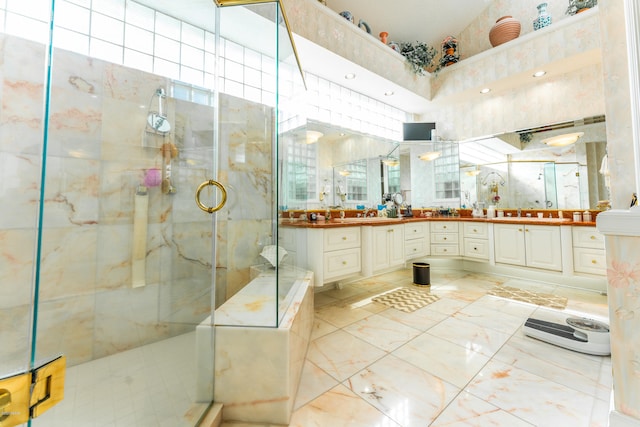 bathroom featuring walk in shower and vanity