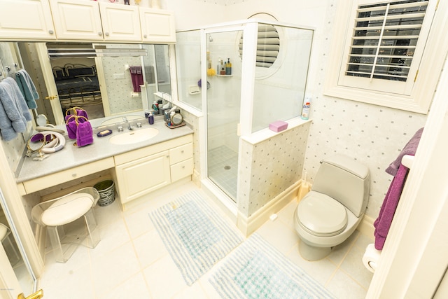 bathroom featuring toilet, vanity, an enclosed shower, and tile patterned floors