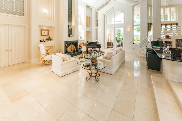 living room featuring a towering ceiling and light tile patterned floors