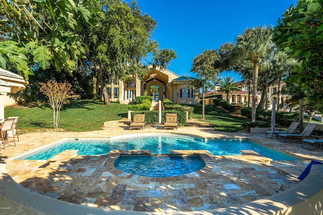 view of swimming pool with an in ground hot tub, a yard, and a patio area