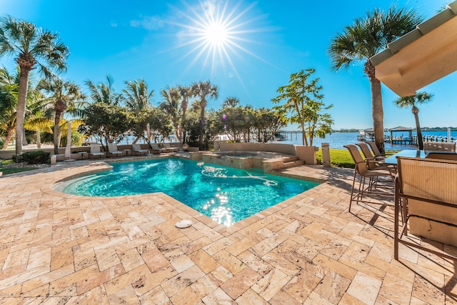 view of pool featuring a water view and a patio area