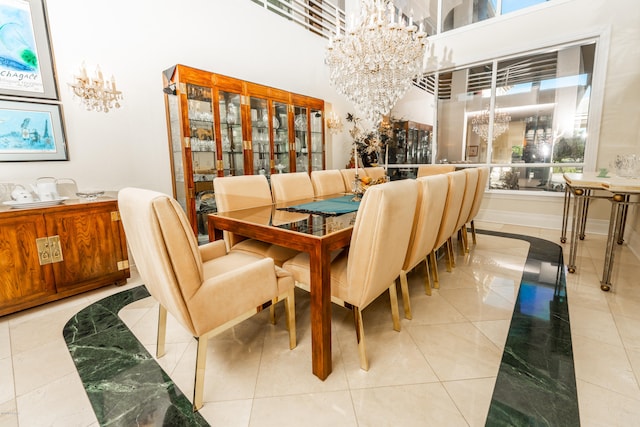 dining space featuring a high ceiling, a chandelier, and light tile patterned floors