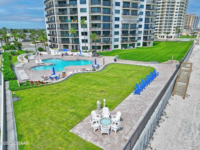 pool featuring a lawn and a patio