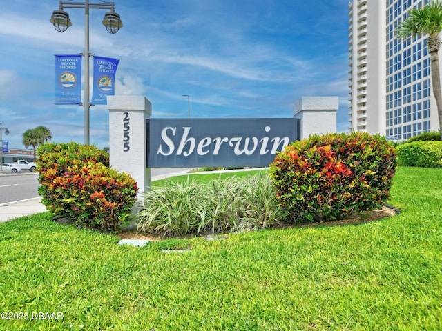 community sign featuring a lawn